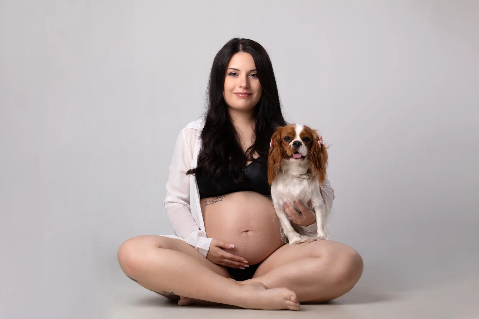 Futura mamma con la sua cagnolina durante un book fotografico gravidanza in studio a Milano
